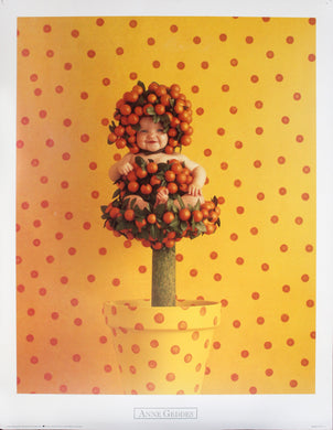 baby sitting in a fake tree of oranges with a yellow and red polka dot background.