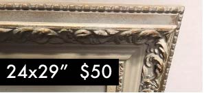 white classic frame 24 inches by 29 inches with beautiful roman like flowers around the center of this old style classic white frame